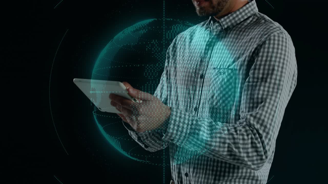 Adult male tapping and swiping tablet in studio, lighting teal globe and dots while presenting tech