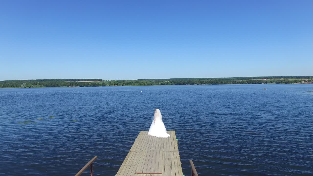 Bride Posing In Her Wedding Day. Aerial shot of a beautiful bride in wedding day outdoors