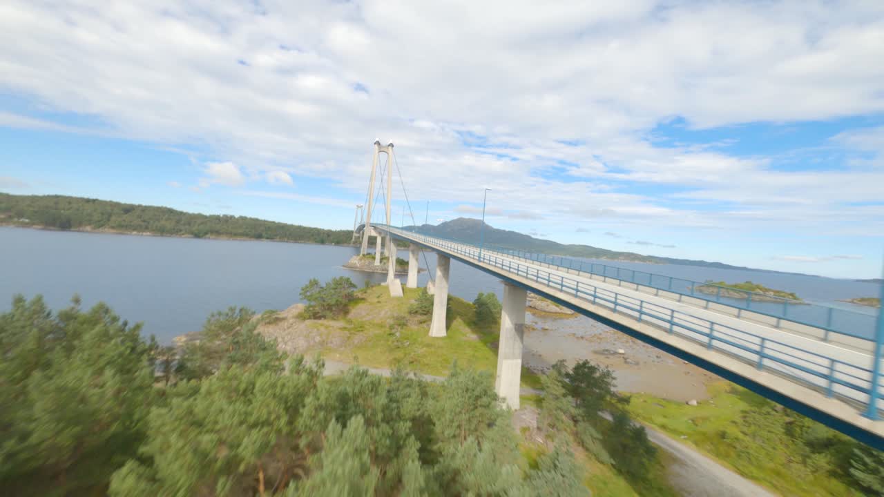 Flying above treetops and alongside of Bomla suspension bridge in Norway, FPV drone view