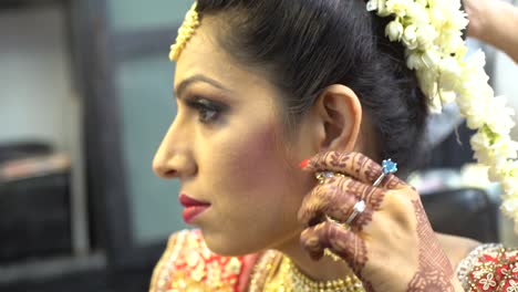 indian girl adjusting her earring and getting ready in a professional beauty salon