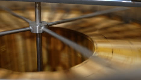 frames with organic honey are rotated in the barrel-like centrifuge machine. beekeepers extracting product from honey frames.