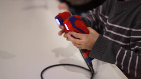 Boy-hand-remote-controlling-robot.-Remote-controller-in-kid-hands