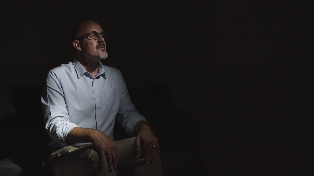 Depressed Mature Man Struggling With Mental Health Sitting In Darkness On Sofa With Low Key Lighting 7