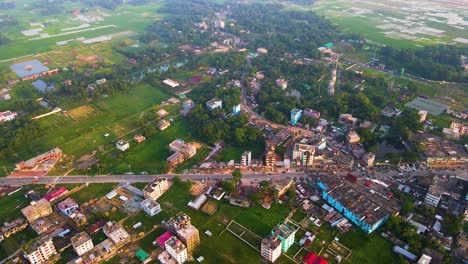 Suburban-city-and-farmland,-Bangladesh,-aerial-establisher,-concept-urbanization