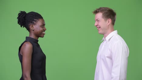 two young multi-ethnic business couple giving hi-five together