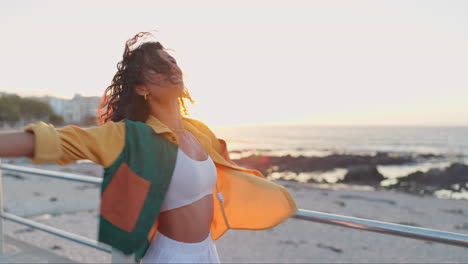 happy woman enjoying sunset at the beach