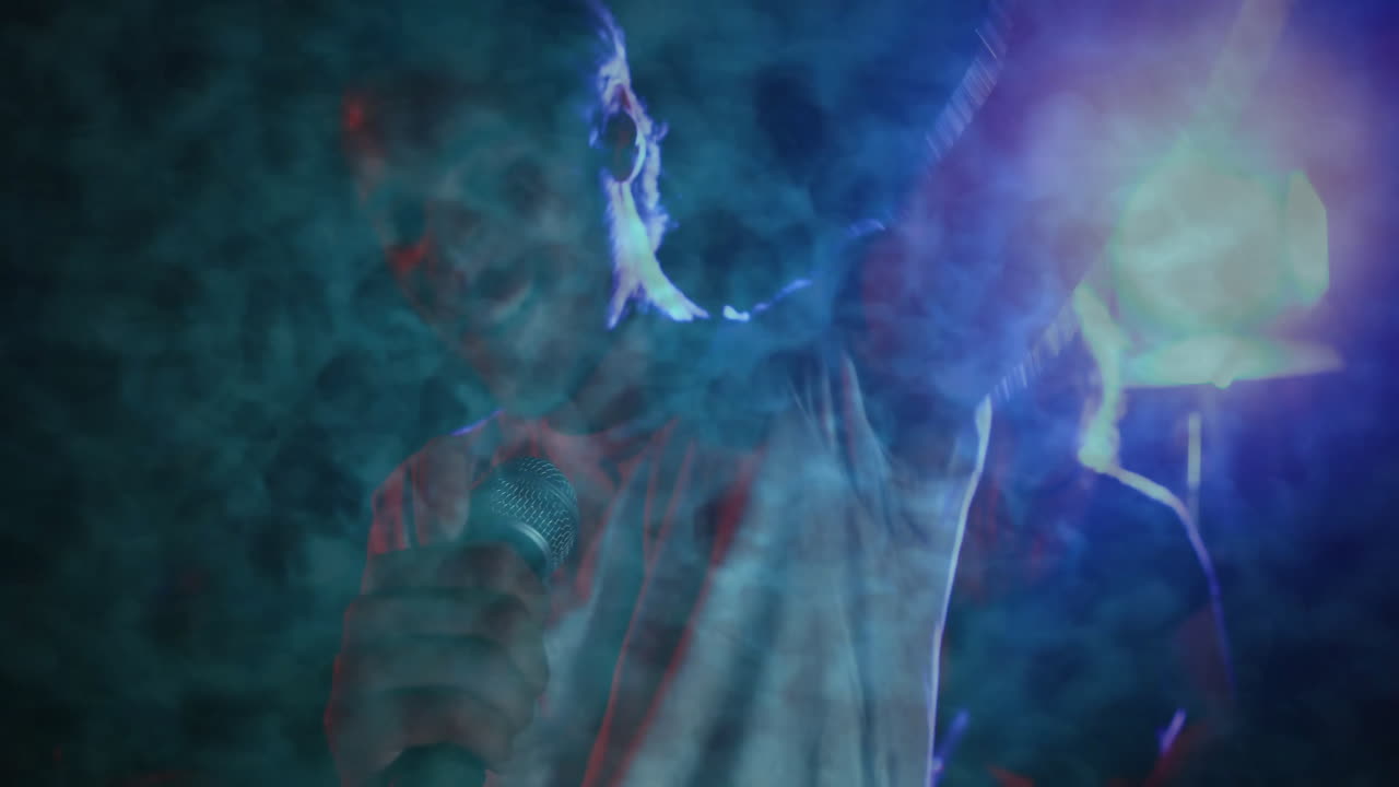 male singer raising arm singing on stage using microphone amid animated smoke for music marketing