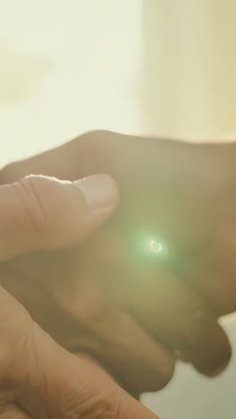 elderly hands holding younger hands in soft morning light