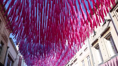 vibrant ribbons adorn a street in libourne