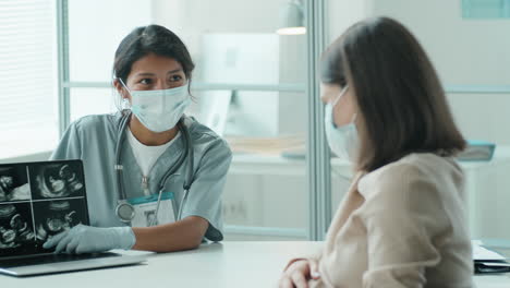 Doctor-in-Mask-Explaining-Ultrasound-Scan-to-Pregnant-Woman