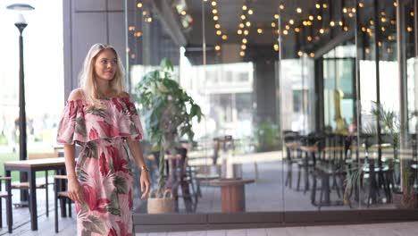 woman in a floral dress at an outdoor cafe