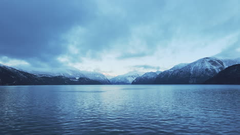 drone flying over storfjorden in sunnmøre, norway with snowcapped mountains