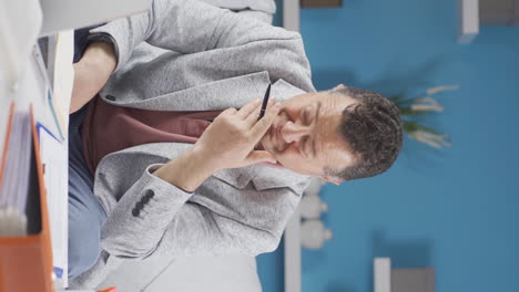 Vertical-video-of-Home-office-worker-old-man-depressed-and-unhappy.