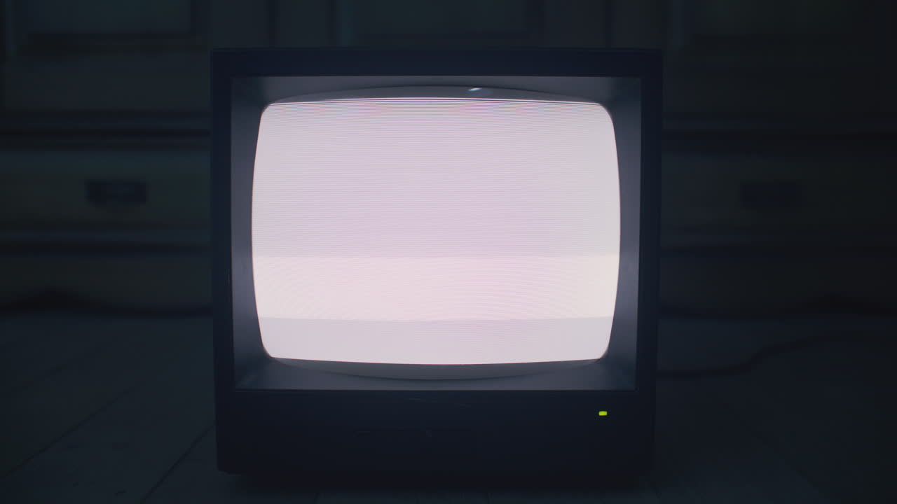 Old Television with Static on a Wooden Floor