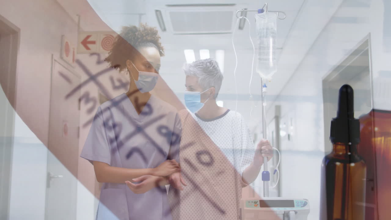 Assisting patient with IV drip, healthcare worker checking medical chart in hospital