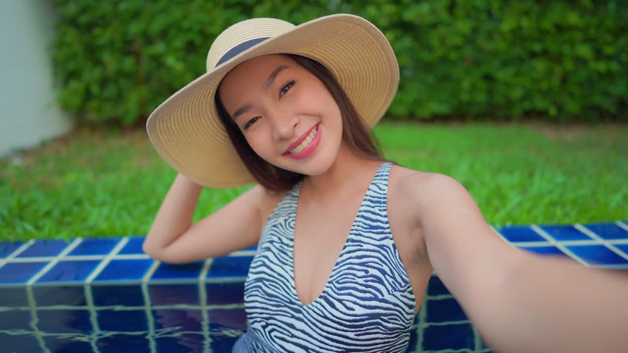 Woman in swimsuit and hat at swimming pool