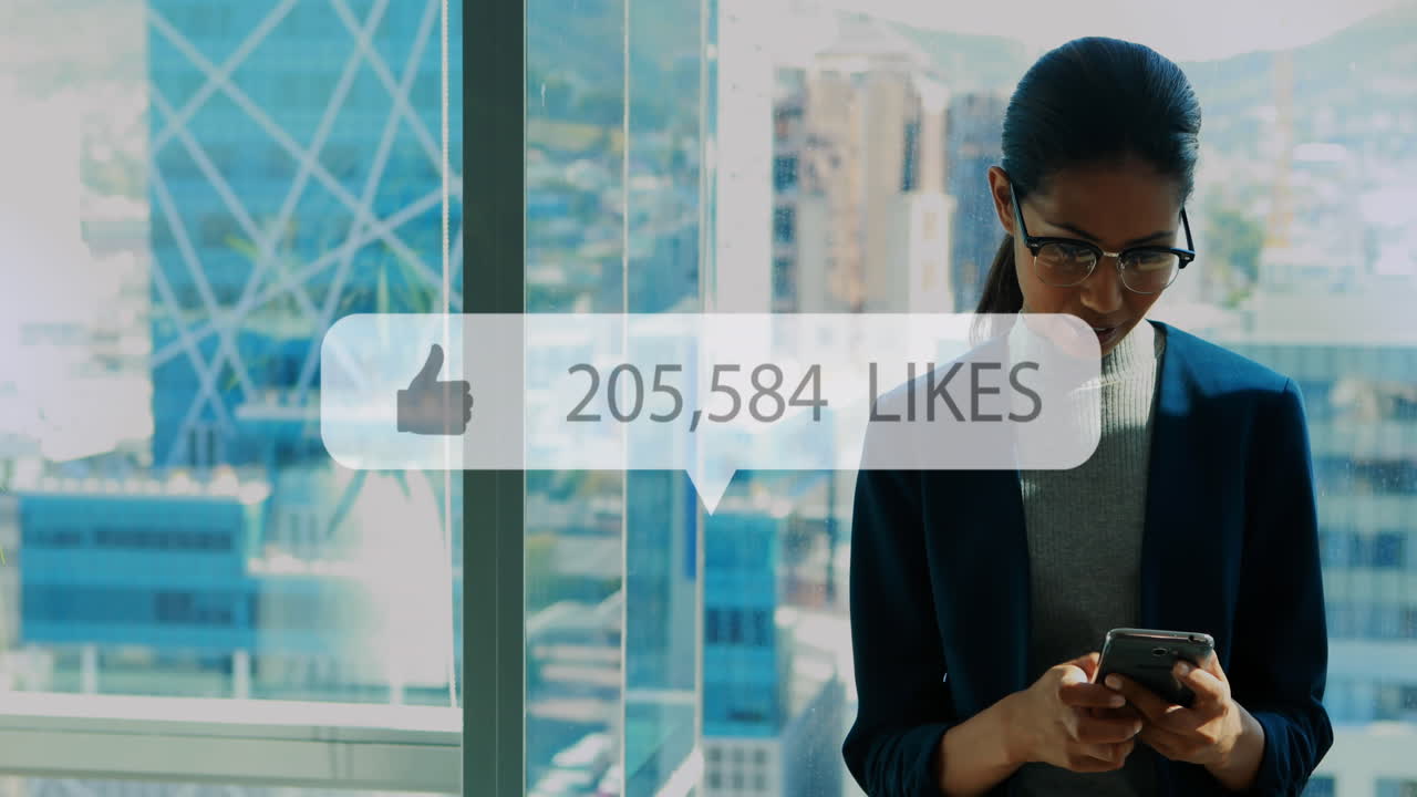 Animation of like icon with growing number over biracial businesswoman using smartphone