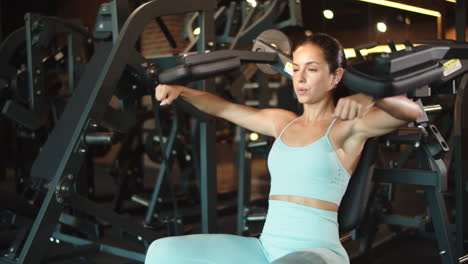 fit girl doing arm curls at gym