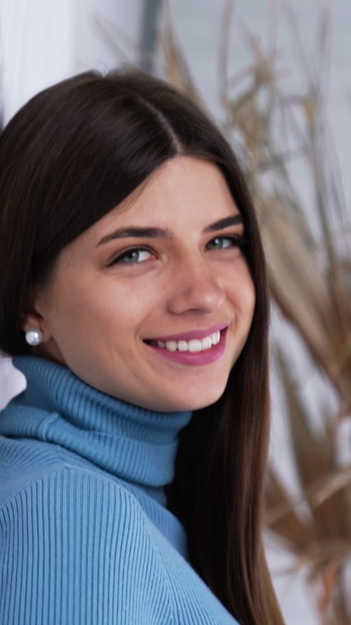 Positive attractive young woman. Pretty young female model posing. Vertical video