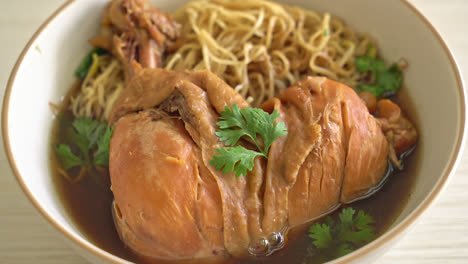 noodles with braised chicken in brown soup bowl - asian food style