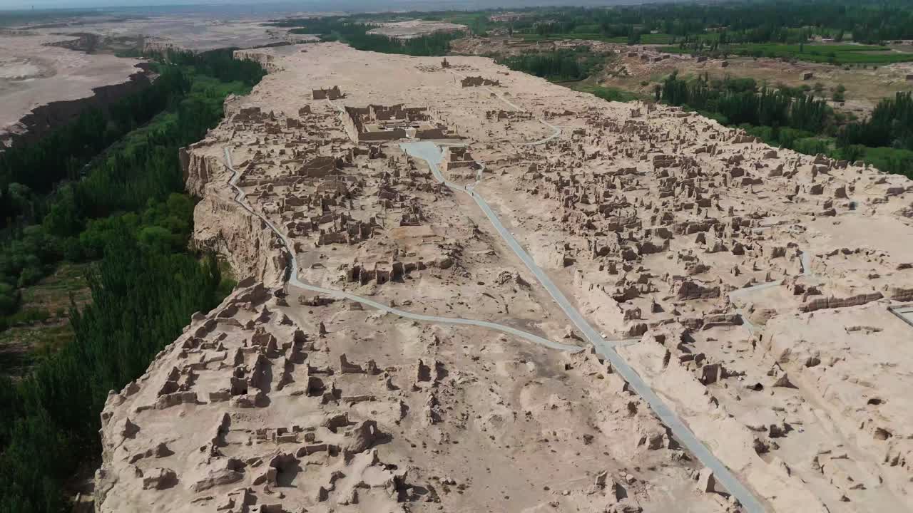 High Altitude Drone Aerial fly Jiaohe Ruins Amidst River Valleys in Turpan, off road beaten path