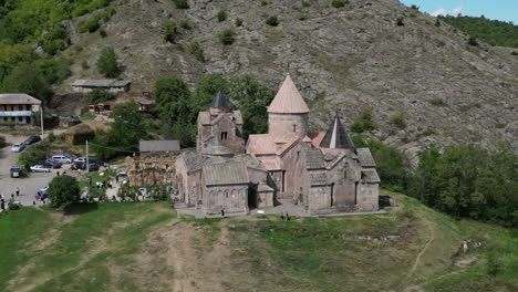 low aerial orbits goshavank monastery as tourists explore the grounds