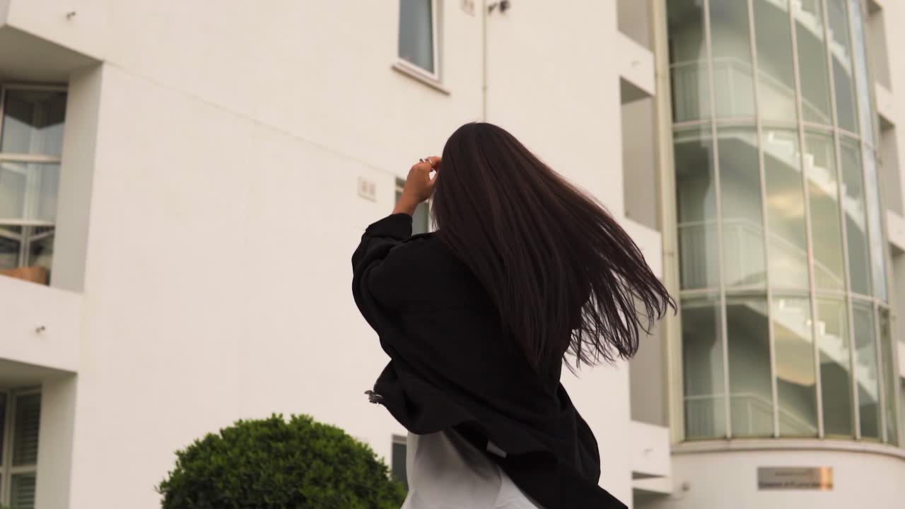 젊고 매력적인 모델 댄서가 새로운 야외 위치를 탐색하고 긍정적인 행복 걷기