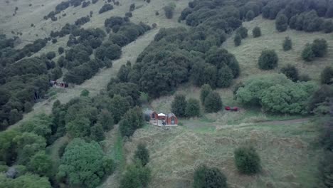 rural hillside landscape with cabins and trees