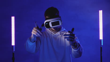 male using a vr headset on a colorful neon light background