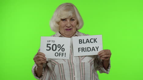 grandmother showing black friday and up to 50 percent off shopping price discount advertisement