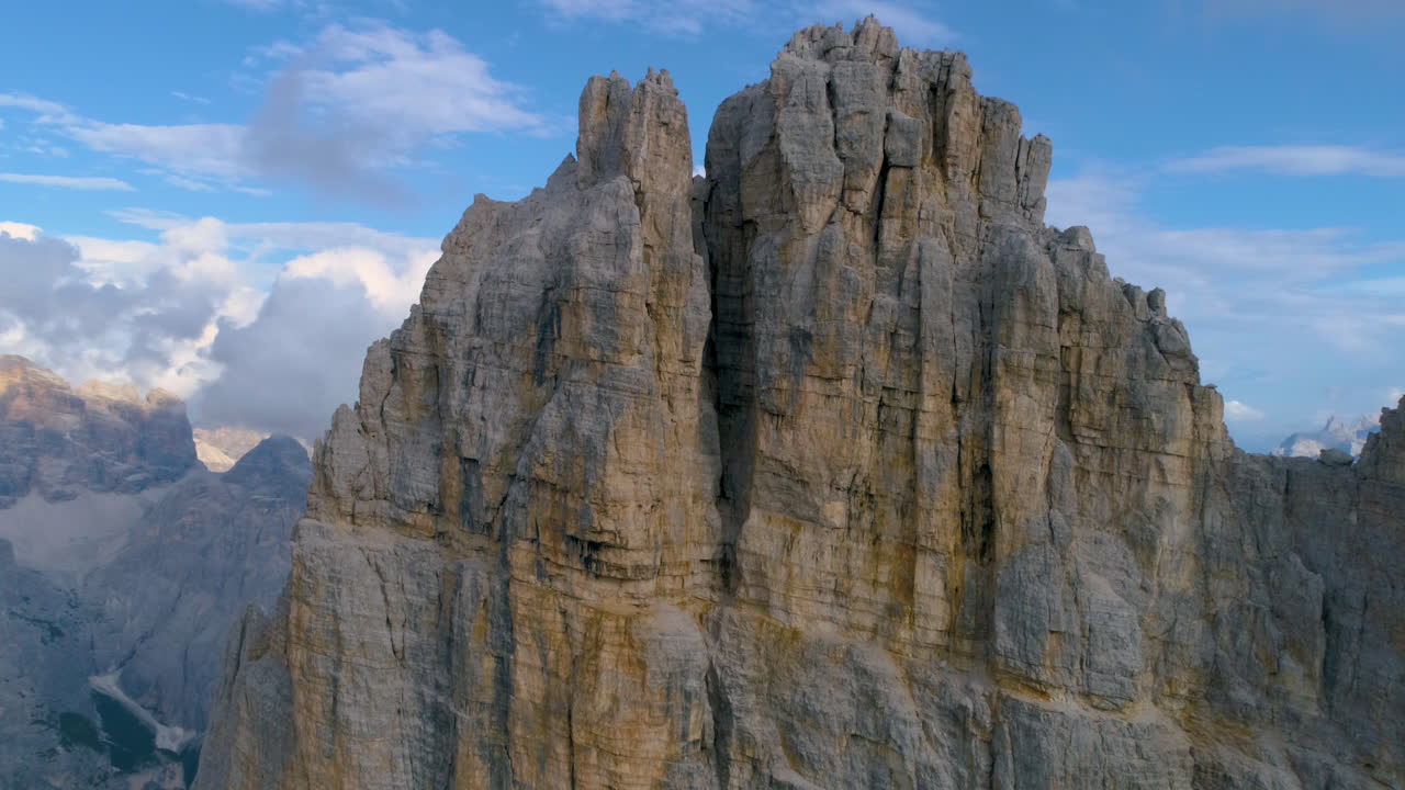 Aerial view flying close to sheer jagged extreme eroded Tre Cime South Tyrol mountain summit
