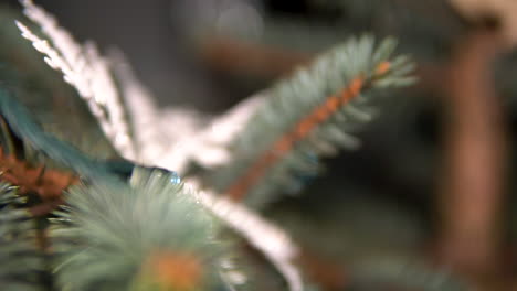 christmas tree leaf with ornaments and lighting wire, selective focus