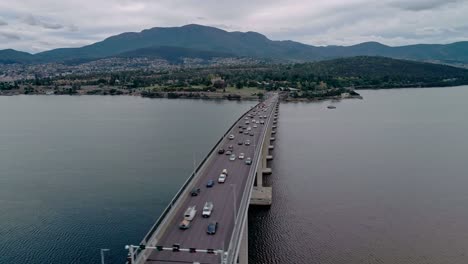 aerial view of a busy bridge with cityscape at background