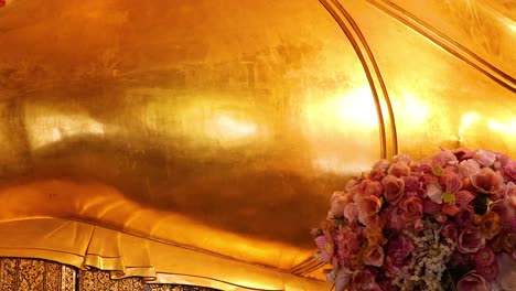 golden buddha statue with floral decorations