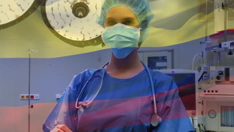 Animation-of-flag-of-colombia-waving-over-anesthesiologist-in-operating-theatre