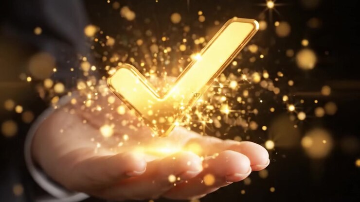 A gleaming golden checkmark held in a hand, symbolizing approval, success, and achievement against a dark backdrop, enhanced by a sparkling effect for emphasis.