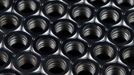 close-up of metal hex nuts arranged in a pattern