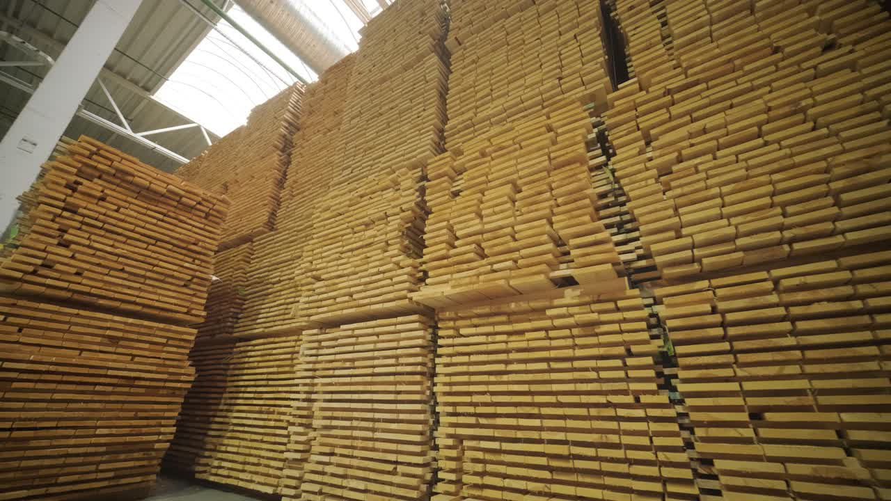 Large Stacks of Wooden Planks in an Industrial Warehouse