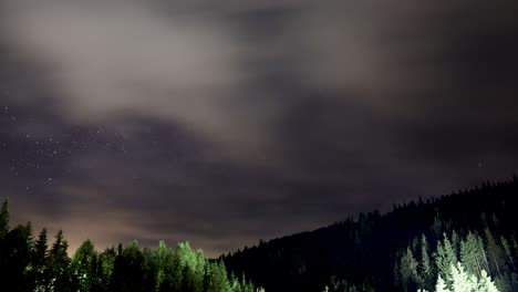 Clouds-Moving-From-The-Starry-Night-Sky-Under-The-Mountain