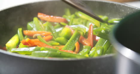 mixing fresh vegetables on pan 1