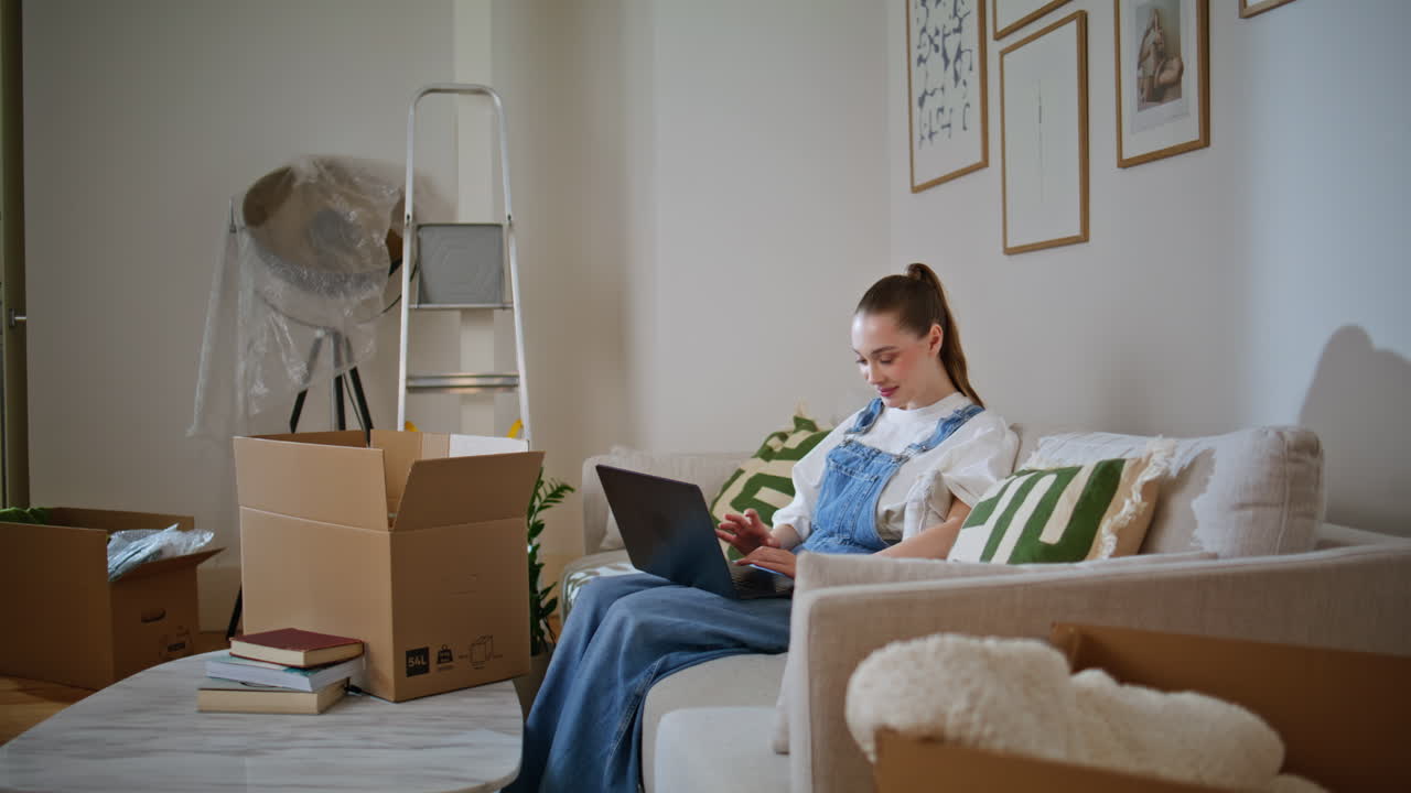Woman browsing furniture e-commerce store on laptop choosing decorations home