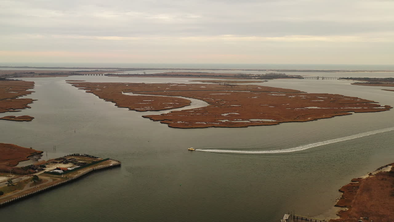 Aerial View of a Boat Passing by an Island in a Calm Ocean