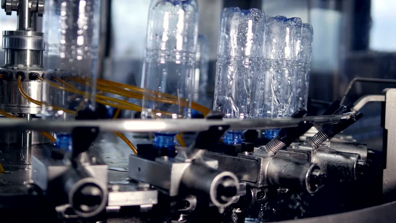 Automatic water bottle rinsing machine.