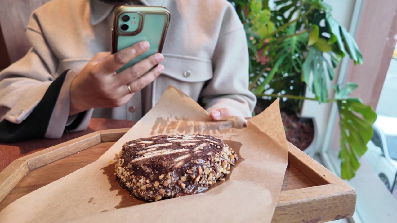 Person Taking a Photo of a Chocolate Dessert in a Cafe