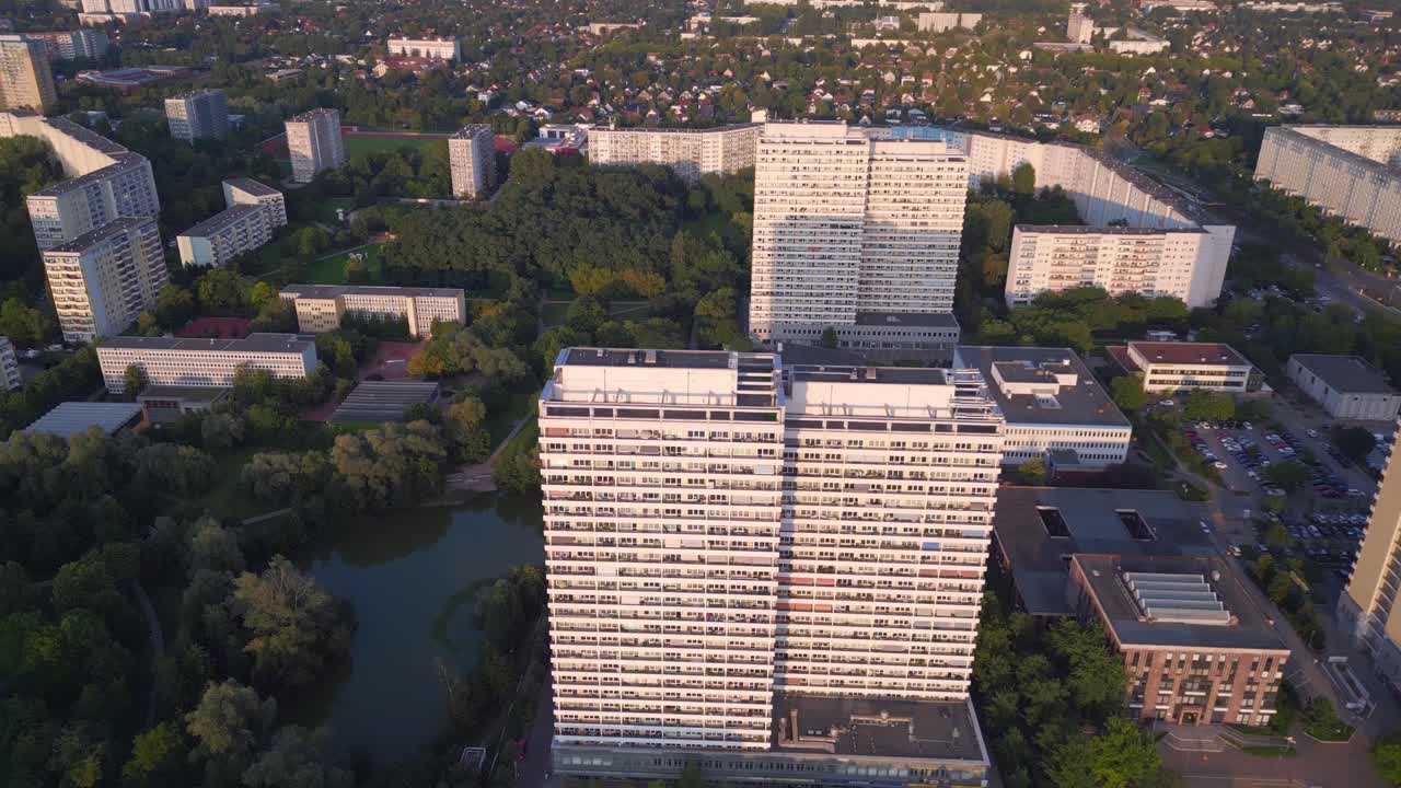 Dramatic aerial top view flight Panel system building, prefabricated housing complex, Berlin Marzahn East Germany golden hour 2023