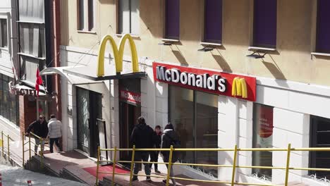 people walking past a mcdonald's restaurant in turkey