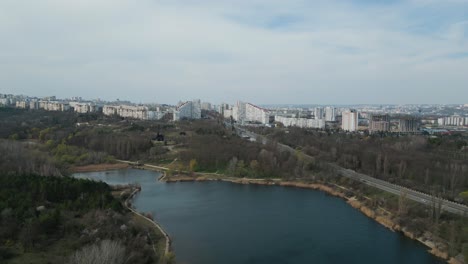 chișinău city gates in moldova - drone flight establishing shot in spring 2023 with lake in the foreground - chisinau bulevardul dacia - aerial 4k panorama bird view