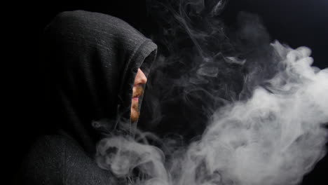 Vapor-billows-out-of-hooded-man