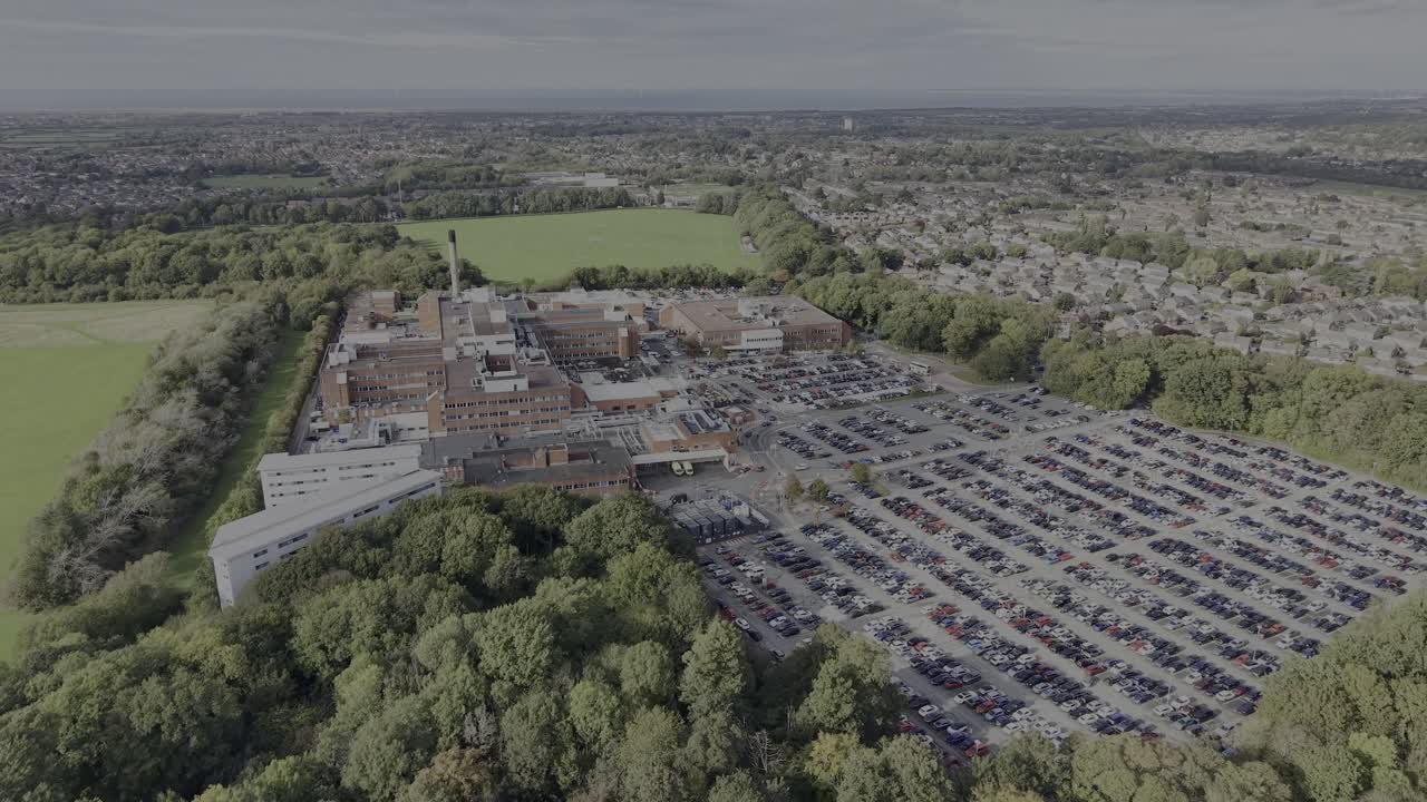 Arrowe Park NHS WUTH Trust Hospital on a sunny autumnal afternoon, drone approach flying over Arrowe Hall - Wirral, UK
