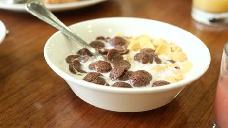 chocolate corn flakes in a bowl on table ,